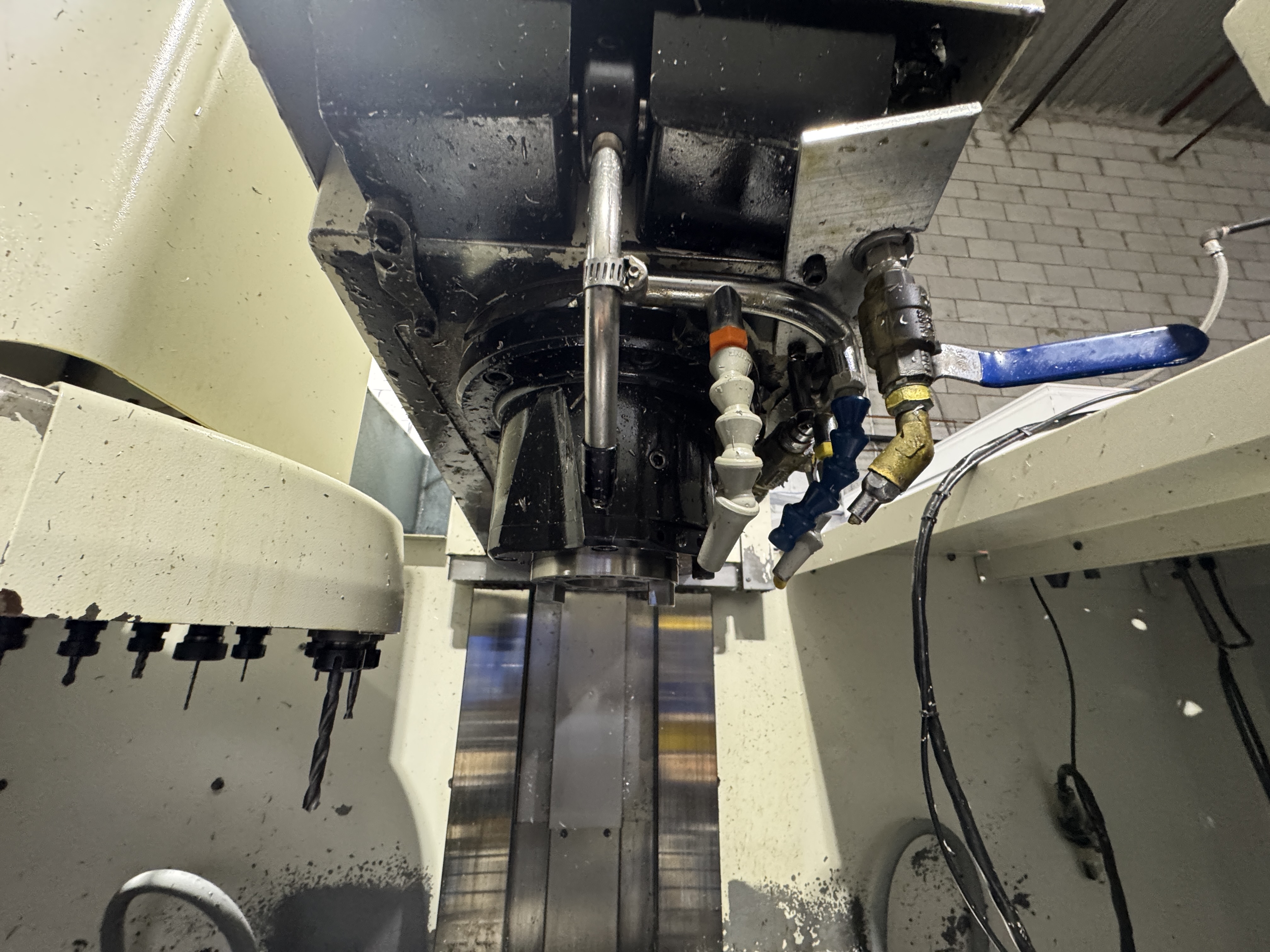 Close-up of a machining center spindle and tooling inside the machine enclosure